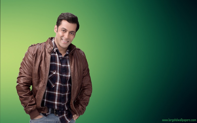 smiling, front view, actor, green color, india, looking at camera, colored background, portrait, waist up, casual clothing, indoors, copy space, confidence