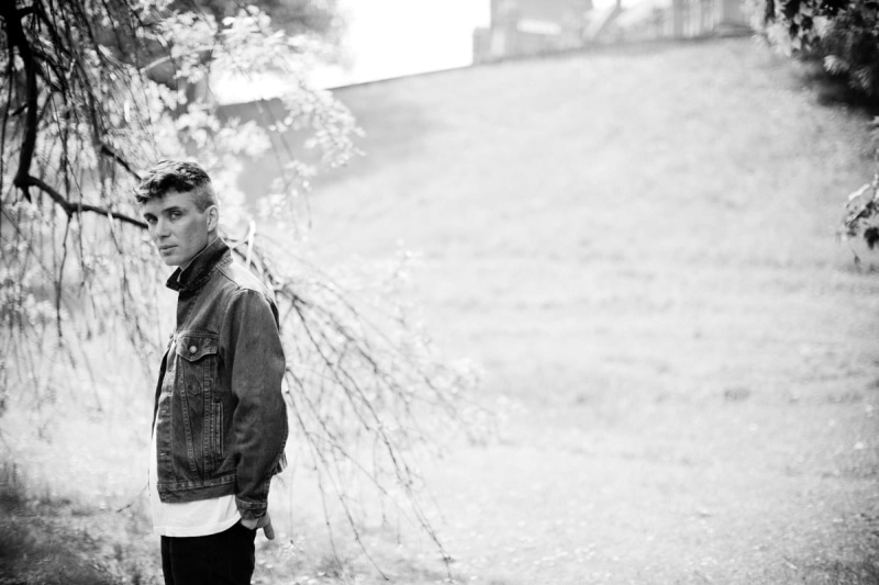 one person, jacket, casual clothing, real people, three quarter length, focus on foreground, man, black and white, clothing, Cillian Murphy, grayscale