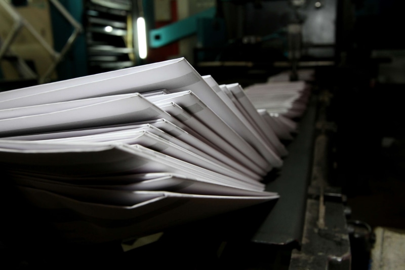 printing press, large group of objects, indoors, no people, printer, communication, paperwork, industrial equipment, abundance, close-up, focus on foreground