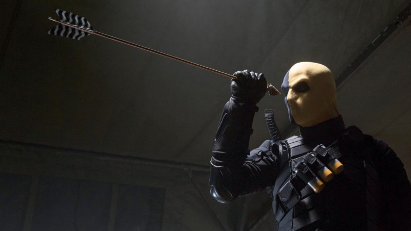 weapon, standing, waist up, adult, archery, dc, indoors, helmet, people, portrait, protection, sport, headwear, men, slade wilson, security