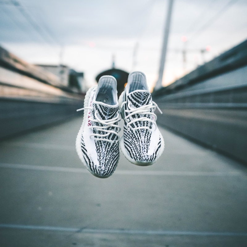 concrete, shallow, selective focus, nike, no people, path, yeezy, mode of transportation, close-up, adidas, absence, pair, urban, bridge - man made structure