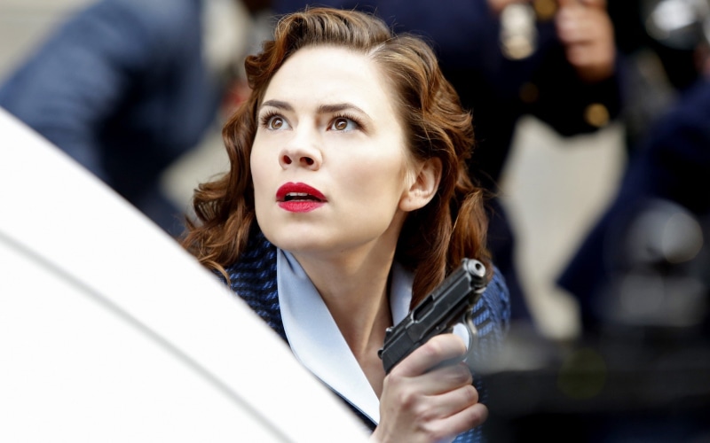 focus on foreground, females, business, movies, pistol, weapon, well-dressed, adult, red lipstick, mid adult, hairstyle, young women, Hayley Atwell, incidental people