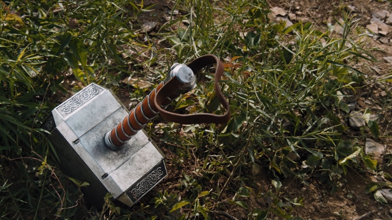 high angle view, beauty in nature, Mjollnir, gardening, earth, one person, shoe, growth, hammer, care, land, grass, green color, plant, Marvel, weapons