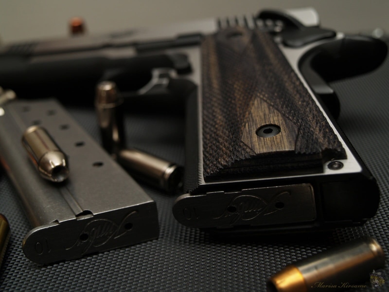 studio shot, semi, handgun, warning sign, M1911, 720P, two objects, still life, technology, no people, gun, bullet, close-up, indoors, music, communication