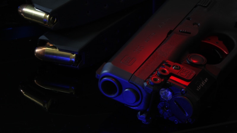 photography themes, Glock, studio shot, night, machine part, retro styled, text, blue, communication, black background, close-up, still life, photographic equipment