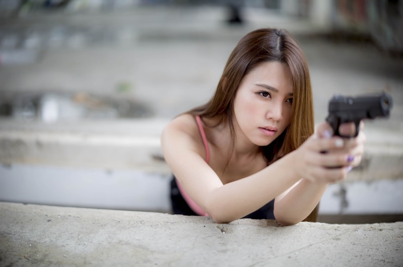 pistol, portrait, 1080P, focus on foreground, leisure activity, young adult, brunette, contemplation, gun, headshot, brown hair, long hair, hairstyle