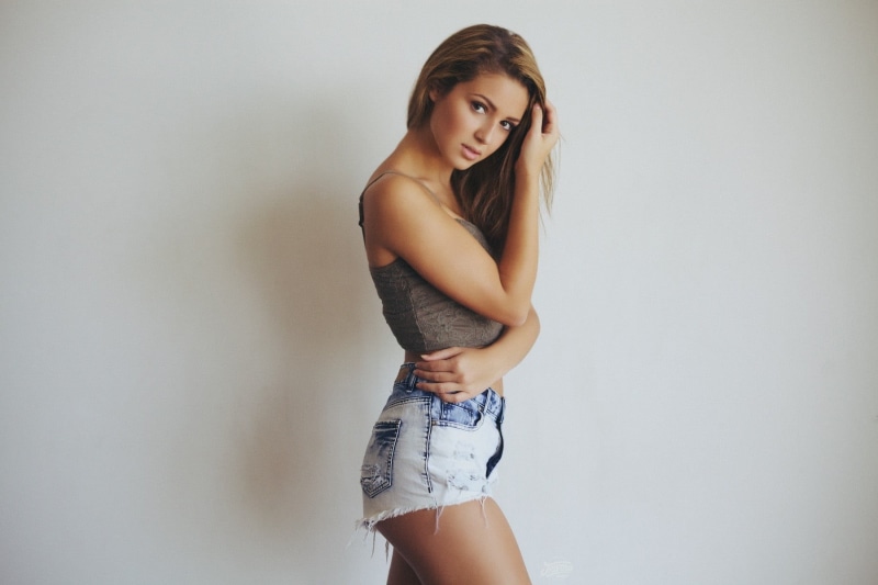 fashion, jean shorts, beautiful woman, young women, young adult, wall, women, portrait, model, standing, studio shot, beauty, indoors, lifestyles, hair