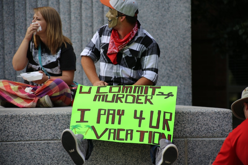 women, teenager, courthouse, man, equality, front view, sitting, law, judge, two people, social issues, symbol, system, hat, real people, innocence, guilt