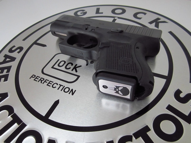 close-up, weapon, indoors, equipment, studio shot, technology, black, glock 26, glock, punisher, western script, power supply, protection, computer, connection