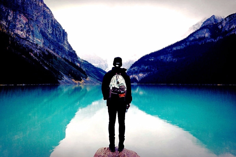scenics - nature, real people, tranquil scene, one person, pullover, full length, lifestyles, leisure activity, sky, tranquility, hoodie, mountains, black