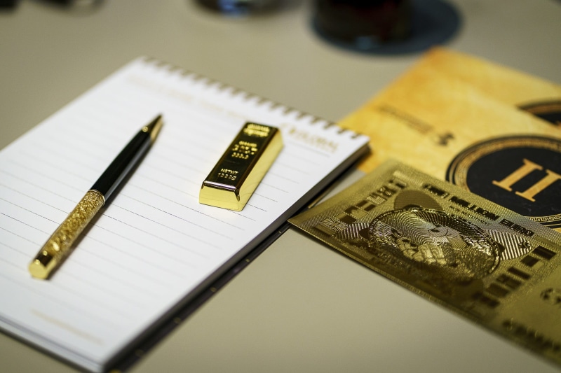 paper currency, gold shop, notebook, gold, communication, table, great heart, indoors, currency, wealth, business, high angle view, gold bars, golden, number