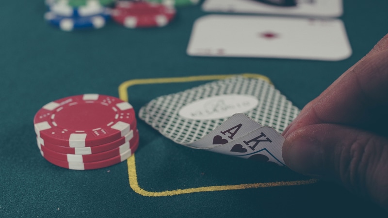 luck, playing cards, focus on foreground, gambling, table, close-up, finger, arts culture and entertainment, one person, opportunity, poker, body part
