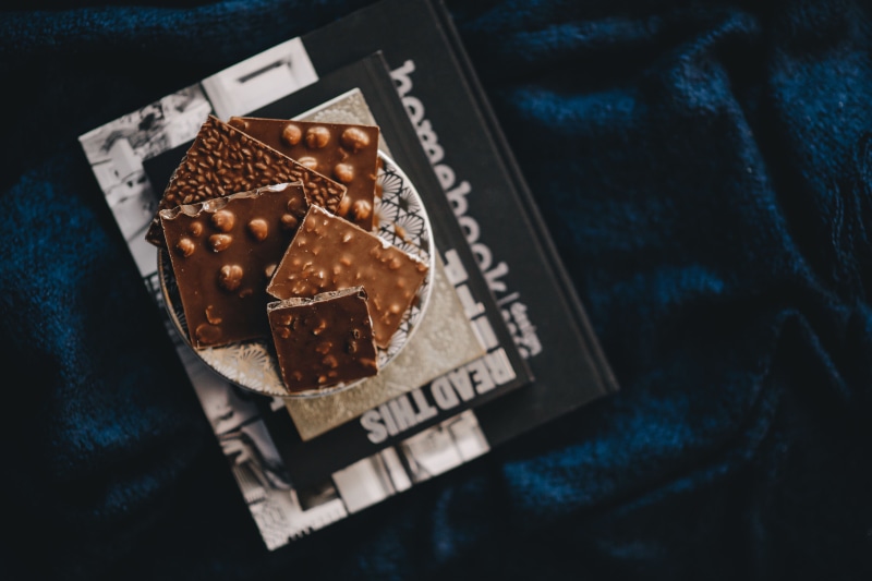 selective focus, sweet, day, baked, textile, 5K, still life, chocolate, bar, table, high angle view, no people, text, chocolate bar, communication, shape