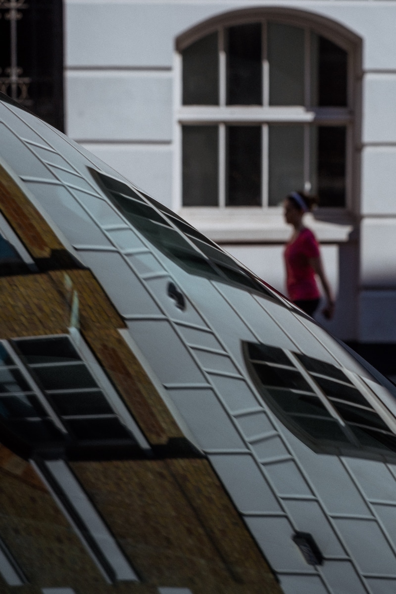 logo, trademark, lifestyles, grey, white, building exterior, built structure, window, house, standing, wheel, person, tire, home decor, human, reflection
