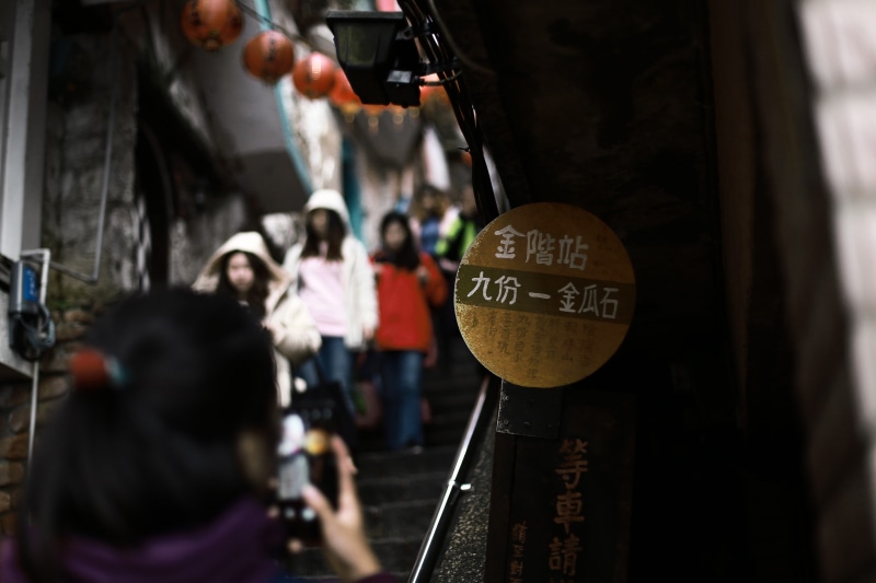 real people, finger, urban, holding, men, coat, photographing, rear view, incidental people, focus on foreground, built structure, adult, beverage, architecture