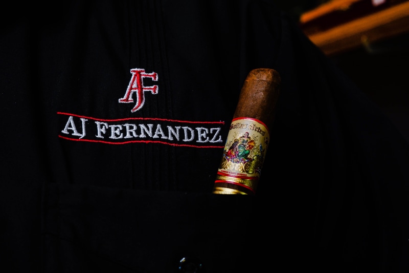 cigar, art and craft, symbol, indoors, black background, beer bottle, dark, trademark, religion, no people, representation, belief, alcohol, usa, florida