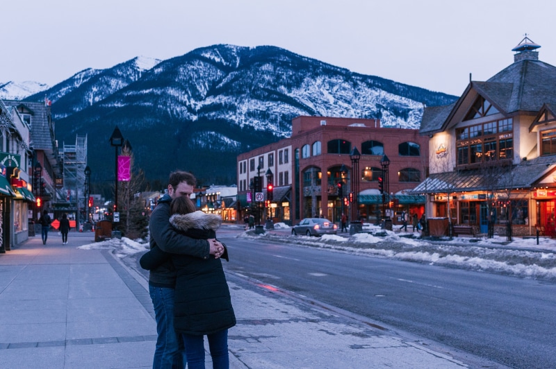 couple, man, windows, cars, sight, winter, shops, road, snow capped, mountain, town, woman, snow capped mountain, one person, people, real people, outdoors