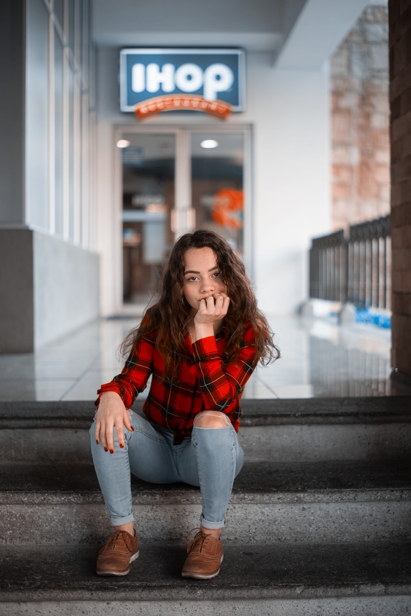 city, stairs, red, casual clothing, focus on foreground, architecture, human, portrait, looking at camera, woman, front view, flooring, communication, shoe