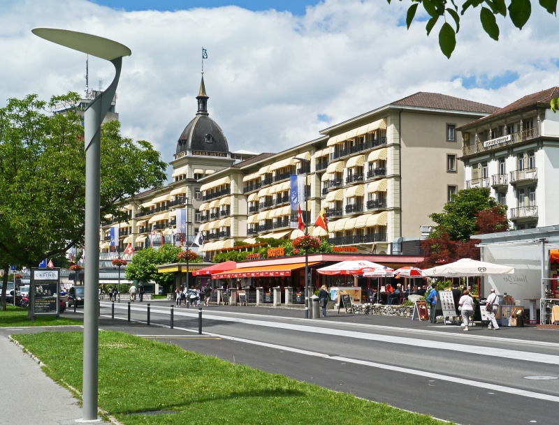 group of people, switzerland, street, plant, 2K, grand hotel, boulevard, road, jungfrau region, sky, city street, city, mode of transportation, tree, built structure