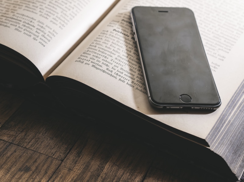 two objects, communication, s, writing, media, school, dark, bookshelf, mobile, closeup, open, internet, space, brown, high angle view, studying, reading