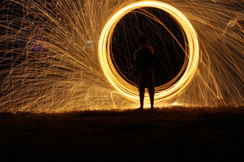 night, one man only, lapse, unrecognizable person, firework, red, lifestyles, men, outdoors, shape, spinning, holiday, wire wool, flame, motion, effect