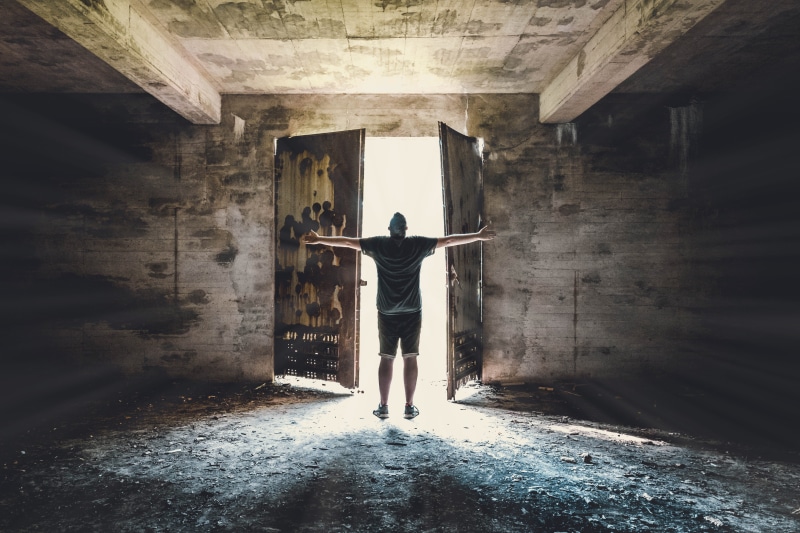 casual clothing, building, arms raised, wall - building feature, steel, rear view, bright, human, young adult, indoors, person, lifestyles, leisure activity