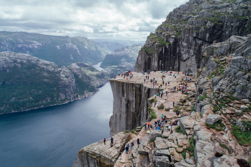 solid, rock - object, bunker, promontory, real people, scenics - nature, river, formation, beauty in nature, mountain range, fjord, mountain, human, leisure activity