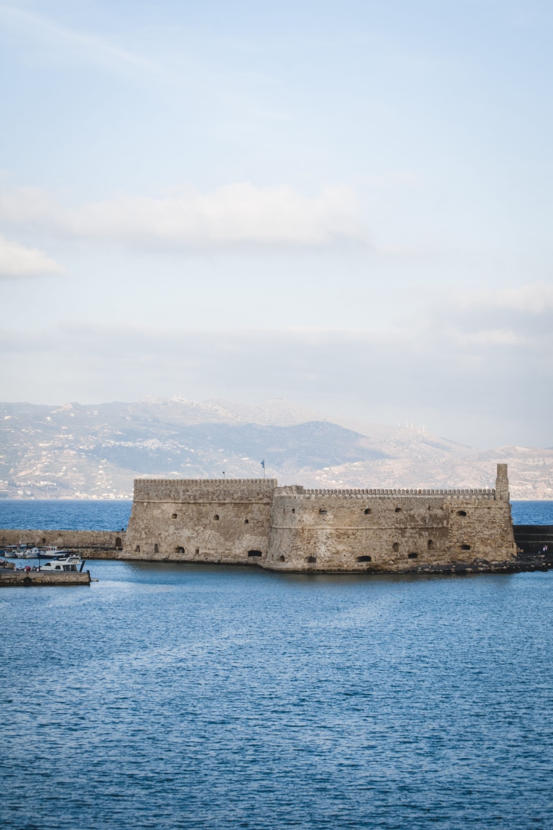 tranquil scene, cloud - sky, nature, waterfront, tower, heraklion, land, greece, architecture, building, fort, built structure, nautical vessel, the past