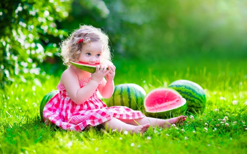 plant, cute, dress, eating, holding, children, full length, blonde, white, food, strap, nature, s, day, outdoors, innocence, mini, girl, food and drink