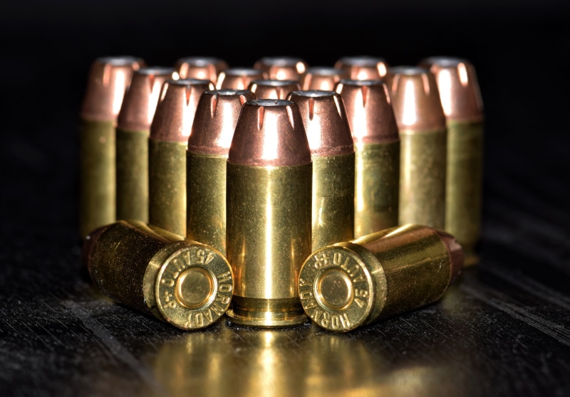 chl, handgun, group of objects, lead, food, ammo, bottle, shell casings, table, load, choice, 45, large group of objects, shells, close-up, still life