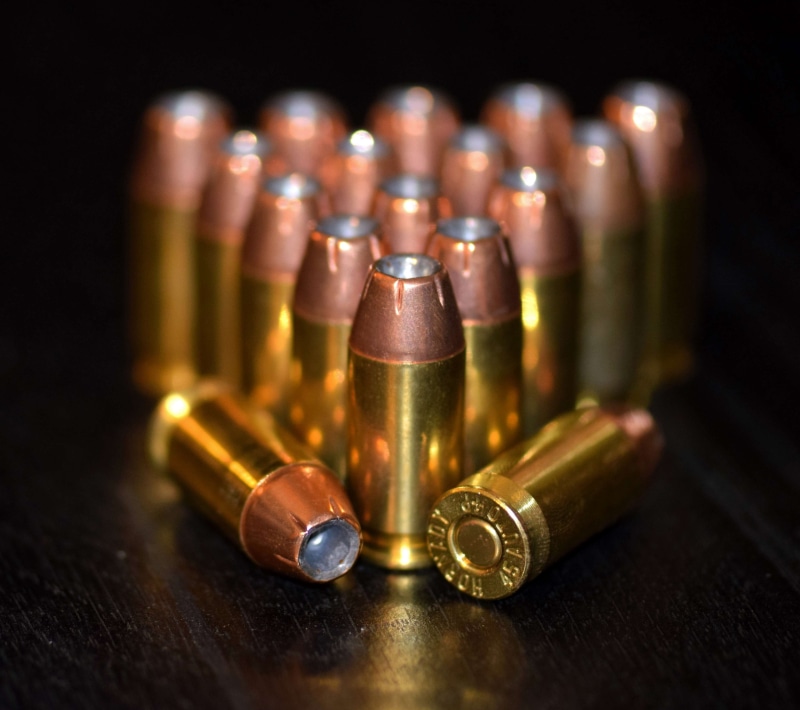 small group of objects, ammo, cartridges, 45 acp, rounds, bullet, hollowpoints, no people, food, bottle, bullets, still life, refreshment, firearms, container