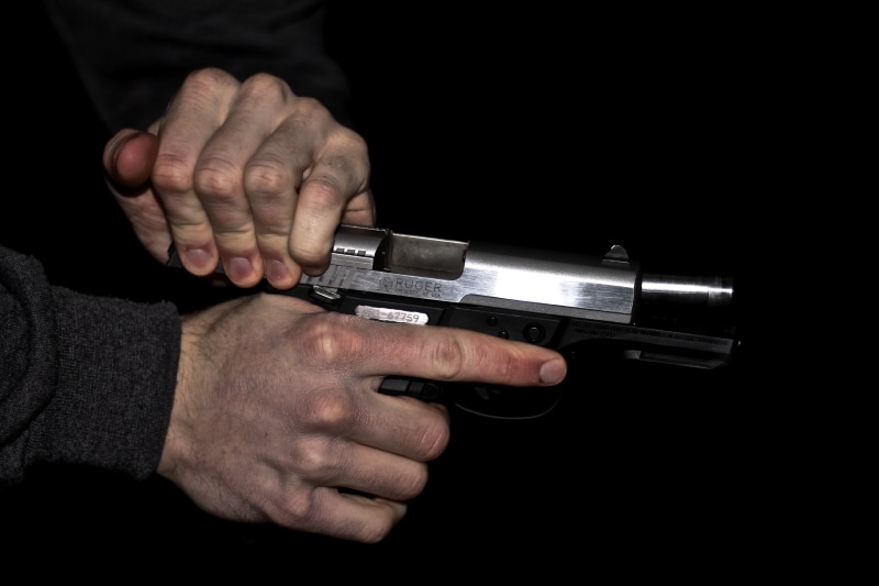 aiming, reload, crime, firing, gun, aggression, communication, human body part, hand, violence, studio shot, finger, shoot, person, gray, pistol, automatic