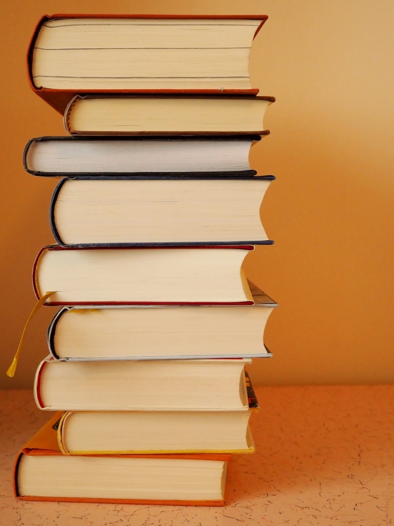 studio shot, near, close-up, literature, group of objects, book, hardcover book, bookcase, know, orange background, stacked, studying, wall - building feature