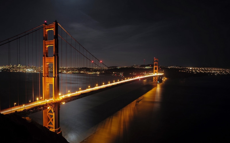 transportation, building exterior, suspension bridge, train, long, night, engineering, connection, outdoors, black, tourism, nature, built structure, sky