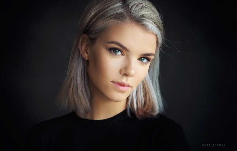 young adult, black color, Sean Archer, contemplation, beautiful people, close-up, face, indoors, simple background, portrait, women, looking at camera