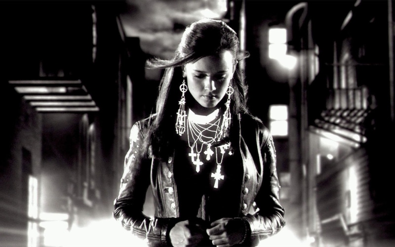 focus on foreground, necklaces, illuminated, photo, happiness, grayscale, one person, looking at camera, leisure activity, smiling, real people, wearing