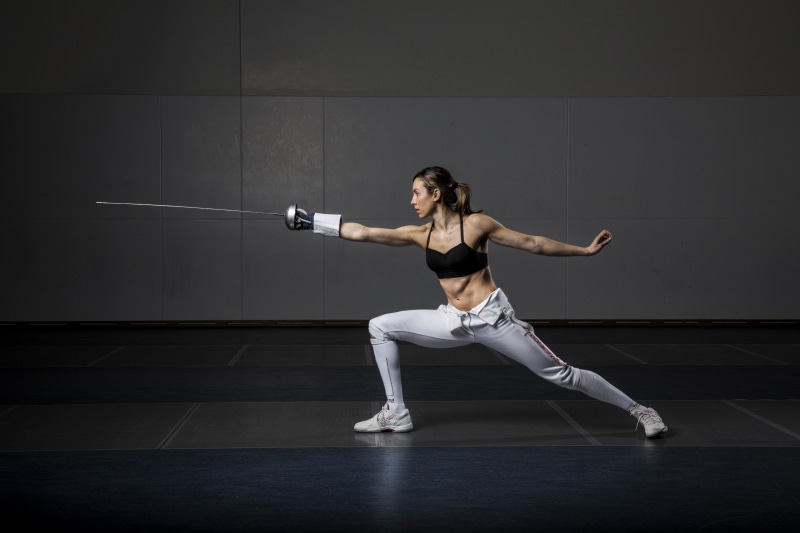 exercising, balance, weight training, fencing (sport), indoors, sports training, one person, healthy lifestyle, muscular build, skill, sports clothing