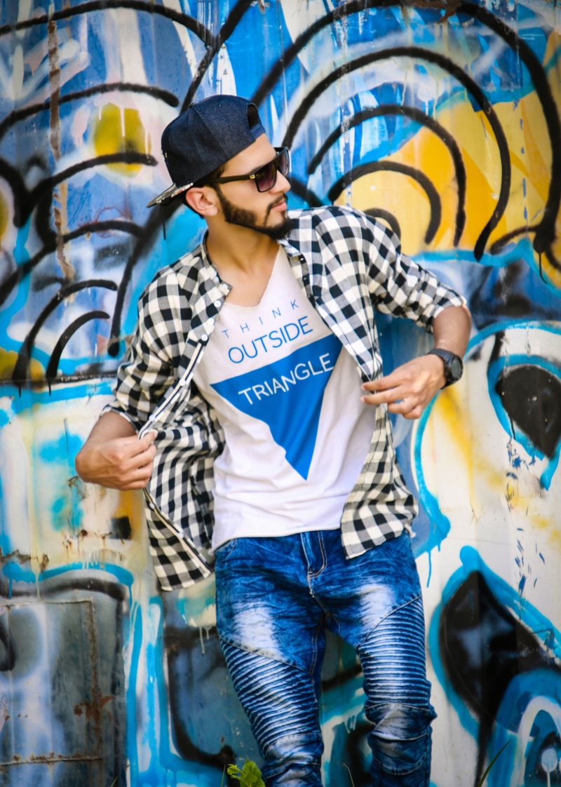 lifestyles, fashion, cap, 4K, front view, wall - building feature, young men, jeans, real people, holding, portrait, look, style, one person, casual clothing