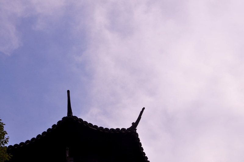 blue, outdoors, religion, cloud - sky, rooftops, built structure, roof, place of worship, spire, spirituality, sky, architecture, eaves, low angle view