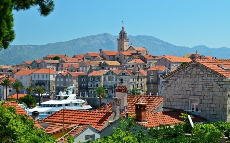 outdoors, built structure, spirituality, clear sky, townscape, no people, city, mountain, rooftops, building exterior, building, residential district, roof tile