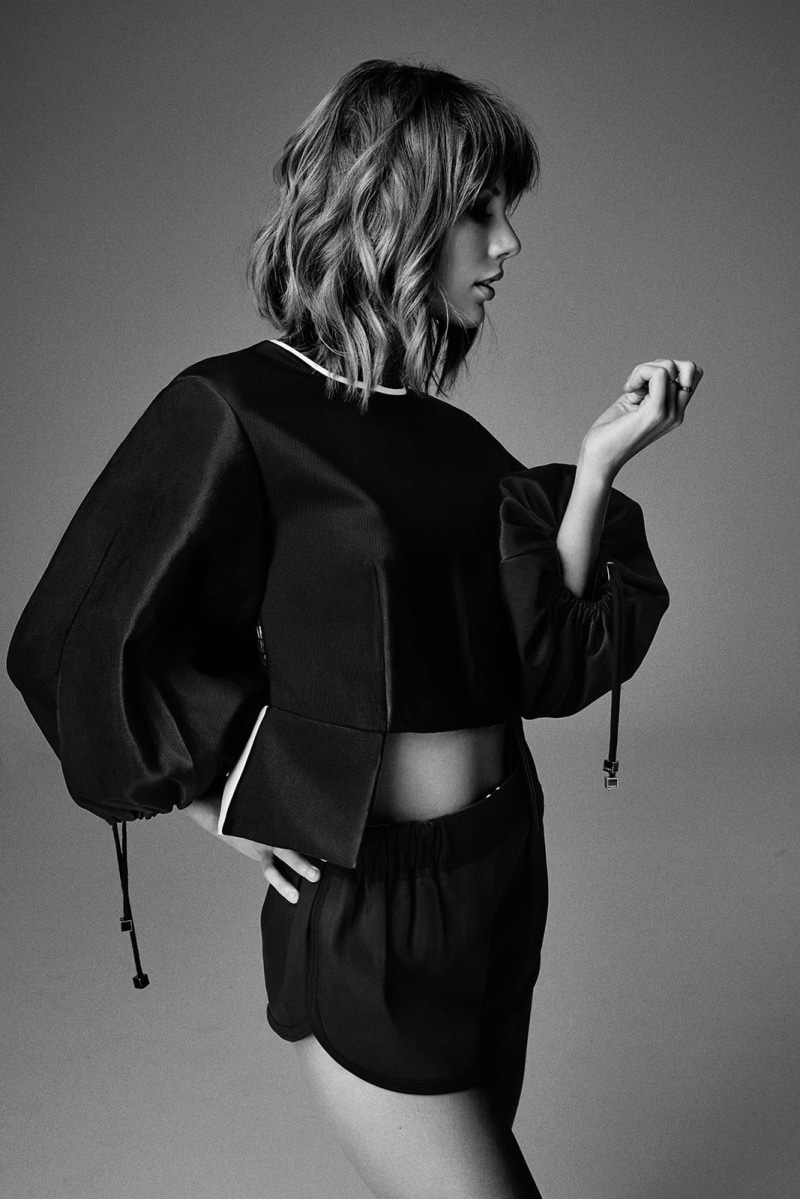 well-dressed, beautiful woman, women, holding, fashion, young adult, indoors, standing, one person, singer, human hair, clothing, profile view, adult, hairstyle