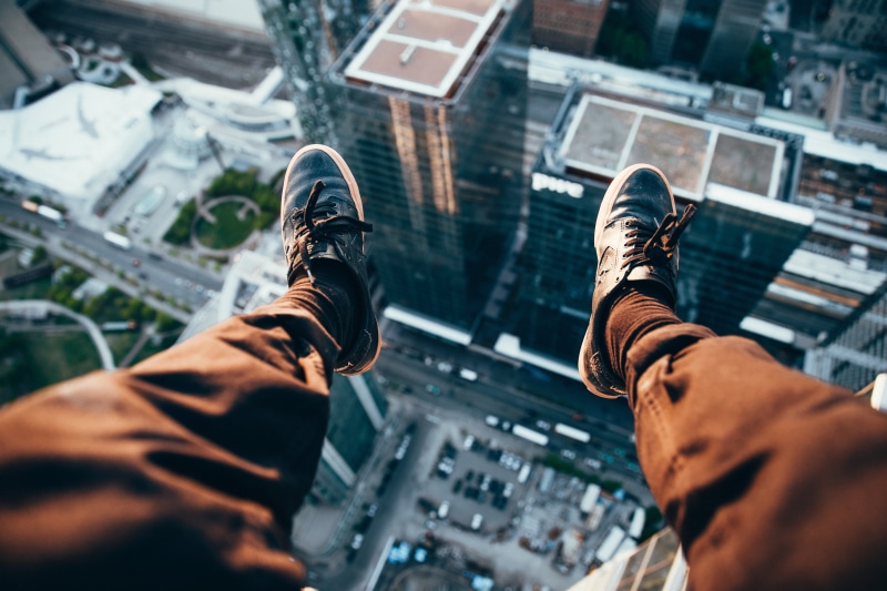 body part, people, city, rooftops, skycrapers, outdoors, human leg, hand, men, two people, low section, jeans, birds eye view, shoe, architecture, built structure