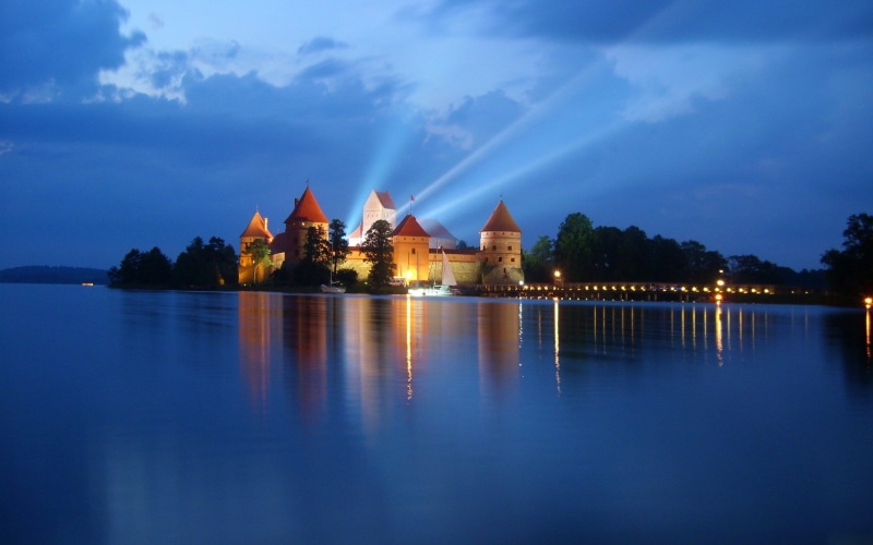 lake, history, dusk, built structure, architecture, religion, water, the past, travel destinations, cloud - sky, sky, gothic style, night, nature, no people