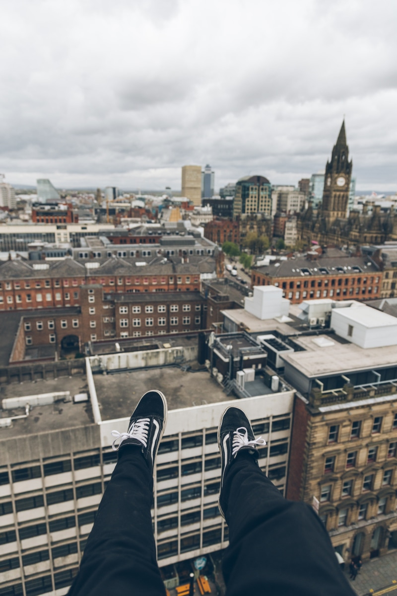 city, lifestyles, feet, roof view, cityline, roof top, human leg, low section, cityscape, sitting, person, building complex, real people, one person, rooftop