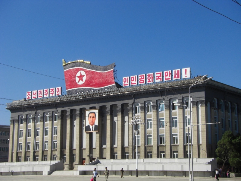 clear sky, dprk, blue sky, day, red, western script, built structure, travel, the korean workers  party headquarters, 2K, flag, the past, travel destinations