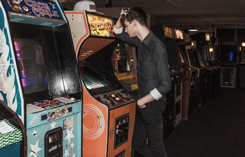 clothing, pants, arcade game machine, slot machine, luck, casual clothing, machinery, retro arcade, arcade games, man, three quarter length, vintage arcade