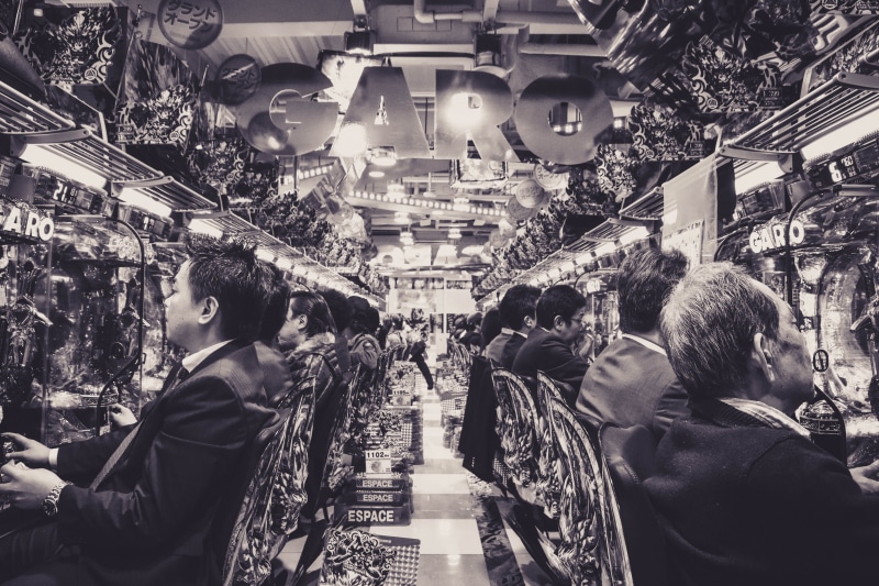 market, money, illuminated, arcade game machine, lighting equipment, pub, shopping, apparel, women, lifestyles, group of people, walking, buying, city life