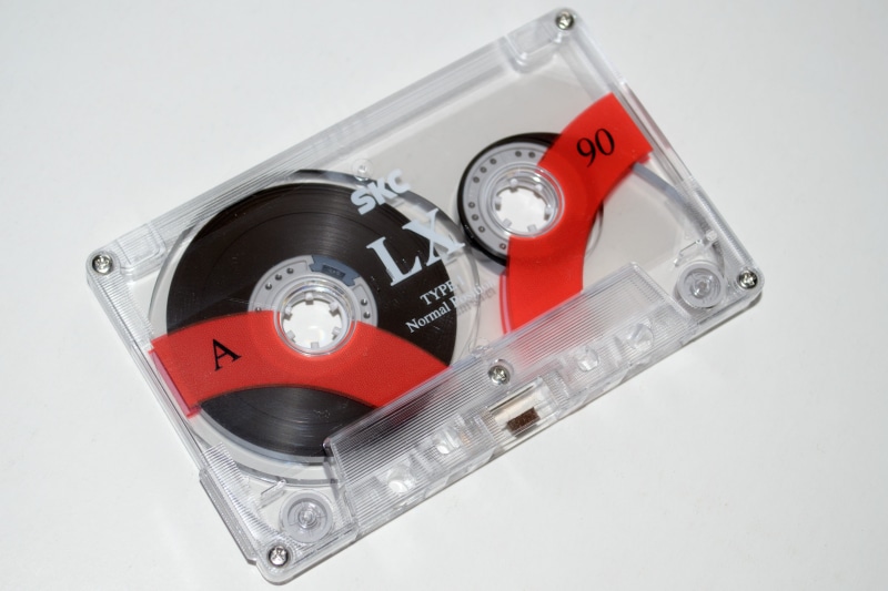 close-up, single object, record, tap, time, magnetic tape, metal, fuel and power generation, technology, music, red, indoors, machinery, cassette, tape