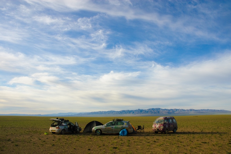 non-urban scene, motor vehicle, convoy, outdoor, horizon over land, 2K, transportation, day, journey, camping, mongolia, steppe, beauty in nature, sky