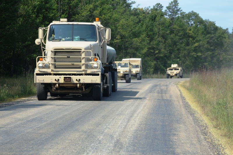 on the move, lorry, commercial land vehicle, motor vehicle, travel, trucking, land vehicle, trailer, land, tree, cargo, delivery, convoy, haul, shipping